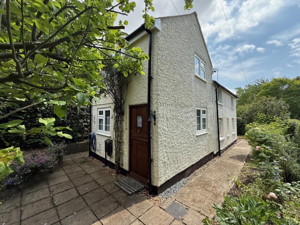 Lot: 150 - PERIOD COTTAGE FOR IMPROVEMENT - Exterior photo of cottage from lawn area